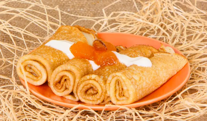 A plate with Peach Cobbler Egg Rolls