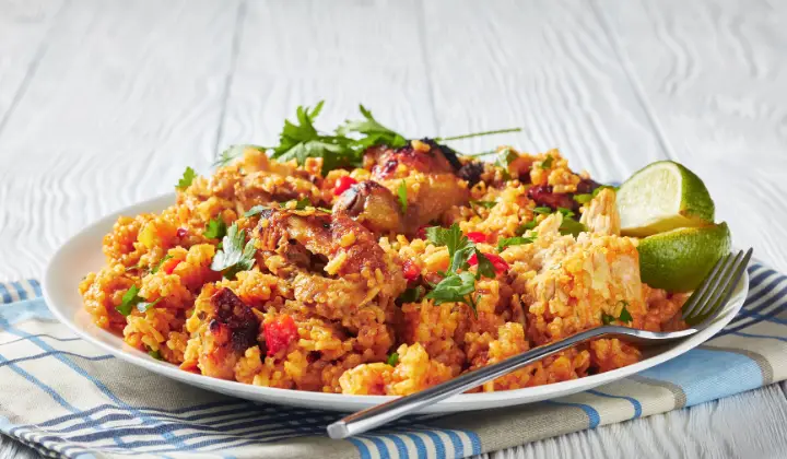 white-plate-topped-with-rice-chicken-and-fork