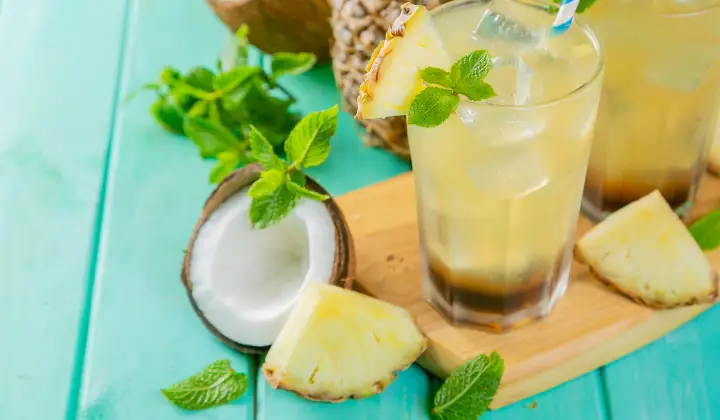 A glass filled with shake of coconut and pineapple 